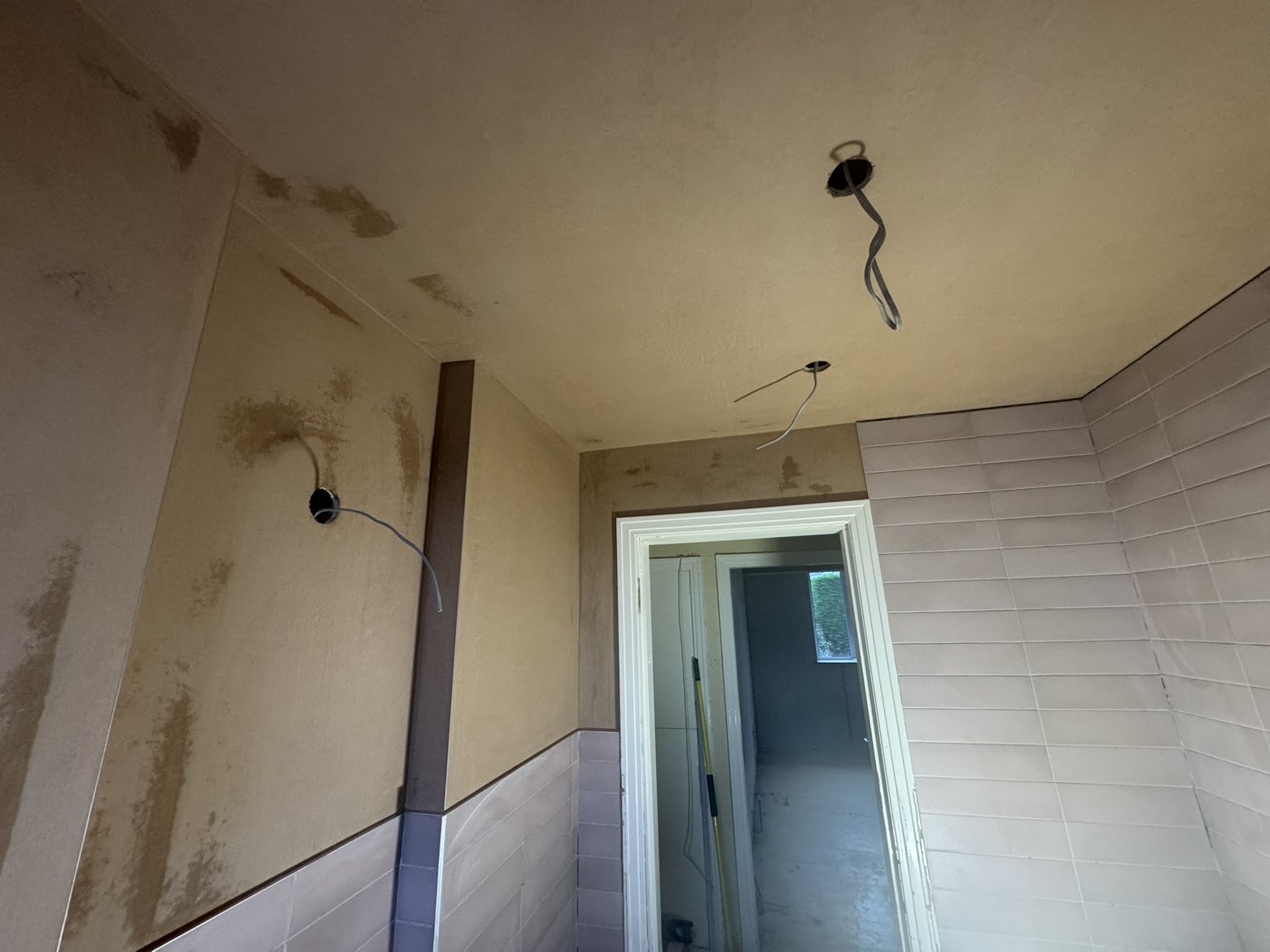 Bathroom walls skimmed around tiles and fittings