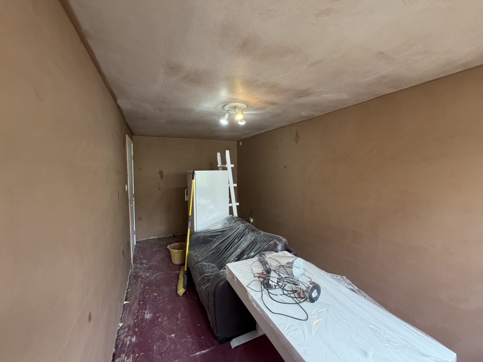 Small room fully re-skimmed with fresh ceiling, walls ready for paint